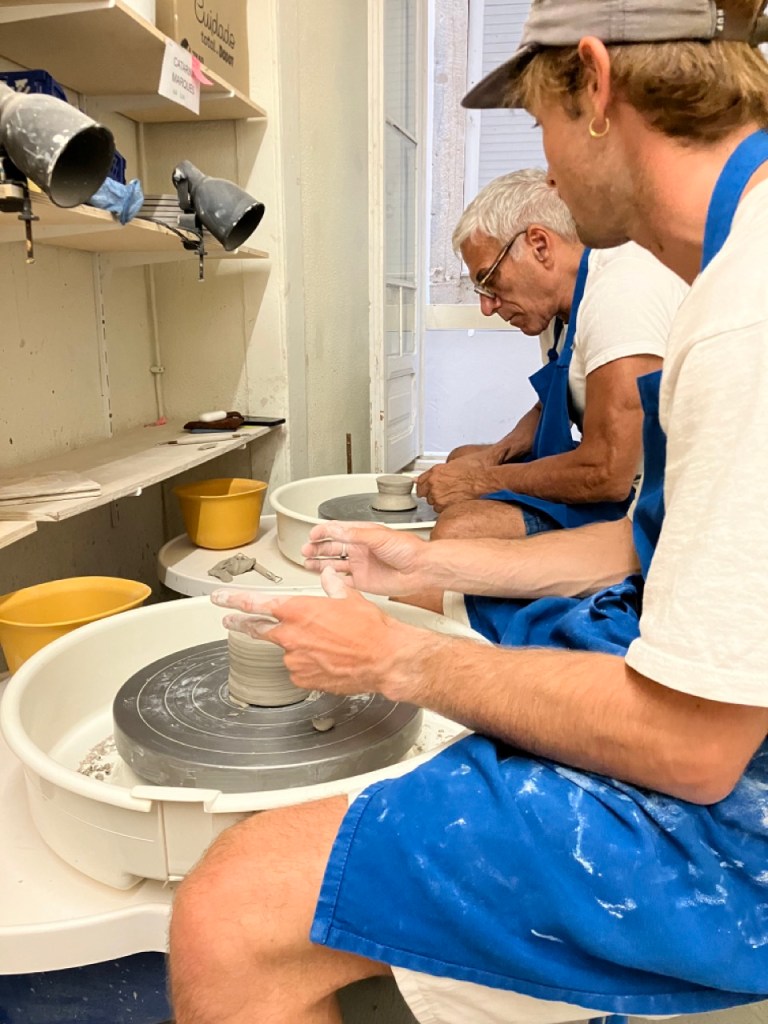 man working at pottery wheel